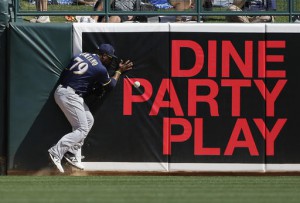 Milwaukee Brewers' Rymer Liriano, cannot catch an RB-double hit by Los Angeles Dodgers' Adrian Gonzalez during the third inning of a spring training baseball game Monday, March 14, 2016, in Phoenix. (AP Photo/Jae C. Hong)