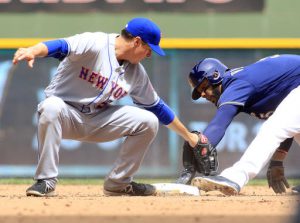 Milwaukee Brewers' Jonathan Villar, right, safety steals second base against New York Mets second baseman Kelly Johnson, left, during the fifth inning of an baseball game Sunday, June 12, 2016, in Milwaukee. (AP Photo/Darren Hauck)