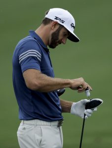 Dustin Johnson makes an adjustment to his driver on the driving range during practice for the Masters golf tournament Monday, April 3, 2017, in Augusta, Ga. (AP Photo/Matt Slocum)