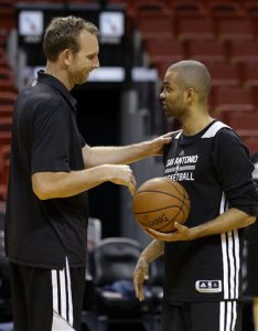 FILE - In this June 11, 2014, file photo, San Antonio Spurs assistant coach Sean Marks, left, talks with Tony Parker during basketball practice at the NBA Finals, in Miami. The Brooklyn Nets have hired Sean Marks of the San Antonio Spurs as their general manager. Marks has spent the last five years with the Spurs, including the last two as assistant general manager.  (AP Photo/Lynne Sladky, File)