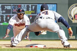 Minnesota Twins third baseman Miguel Sano, left, tries to extend a double into a triple and slides into the tag of Detroit Tigers third baseman Mike Aviles to end a baseball game Sunday, May 1, 2016, in Minneapolis. (AP Photo/Bruce Kluckhohn)