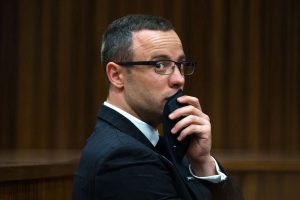 ARCHIVO - En imagen de archivo del martes 19 de mayo de 2014, Oscar Pistorius escucha la evidencia psiquiátrica de su defensa, durante el juicio en su contra por asesinato, en Pretoria, Sudáfrica. (AP Foto/Daniel Born, Pool, archivo)