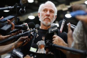 San Antonio Spurs coach Gregg Popovich keeps his emotions in check as he addresses the media during an NBA basketball news conference, Tuesday, July 12, 2016, in San Antonio, the day after Tim Duncan announced his retirement. Popovich wore a T-shirt with the likeness of Duncan as he reflected on his relationship with the 19-year Spurs veteran and talked about his contributions to the team and to him personally. (Kin Man Hui/The San Antonio Express-News via AP)